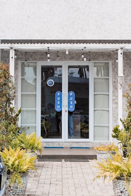 Community center entrance with welcoming doors and a bulletin board outside