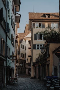 a cobblestone street lined with tall buildings