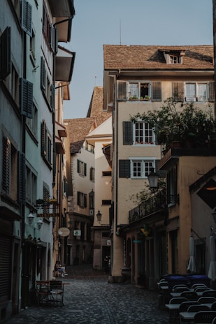 a cobblestone street lined with tall buildings