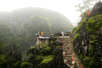 A scenic view of Guizhou's lush mountains with travelers enjoying a guided tour.