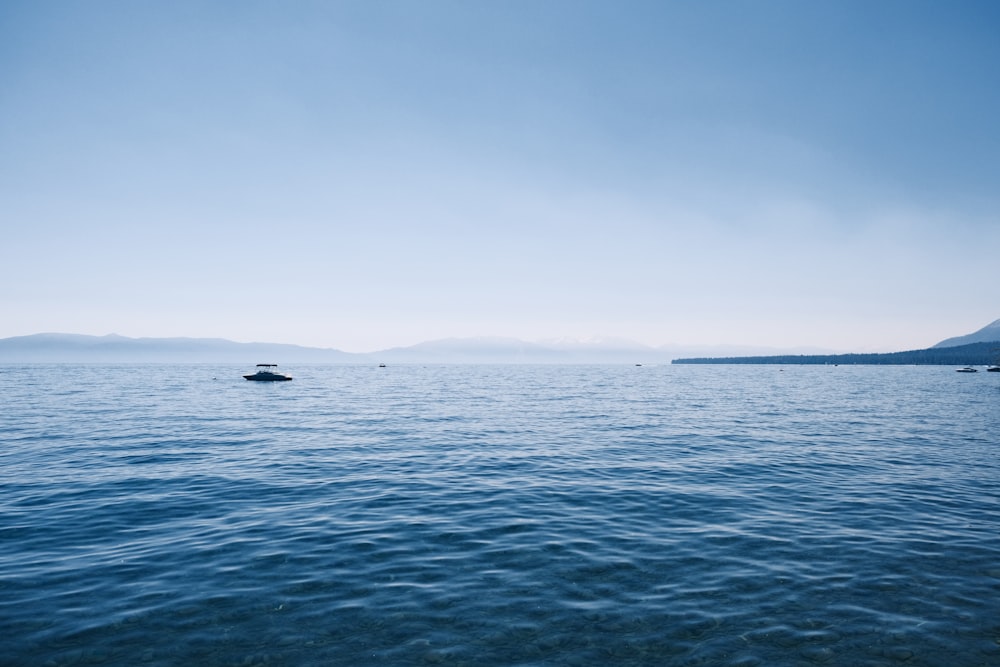 a boat floating on top of a large body of water