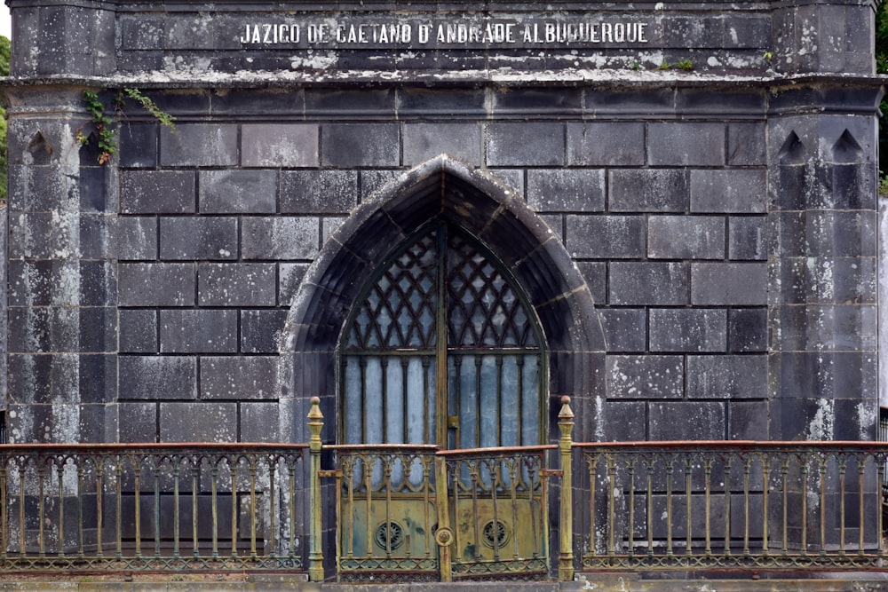 an old building with a gate and a sign on it