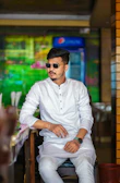 A casual outfit featuring a khawani & co men's shirt and chinos, captured in a cozy café setting.