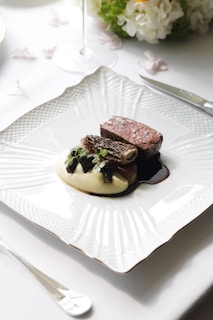 a plate of food on a table with utensils