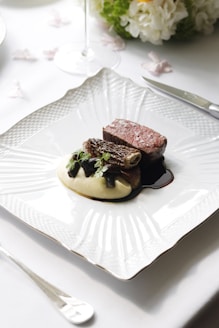 a plate of food on a table with utensils