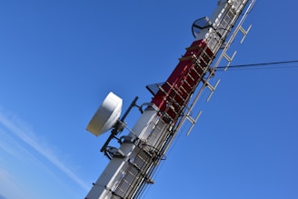 a cell phone tower with a lot of antennas on top of it