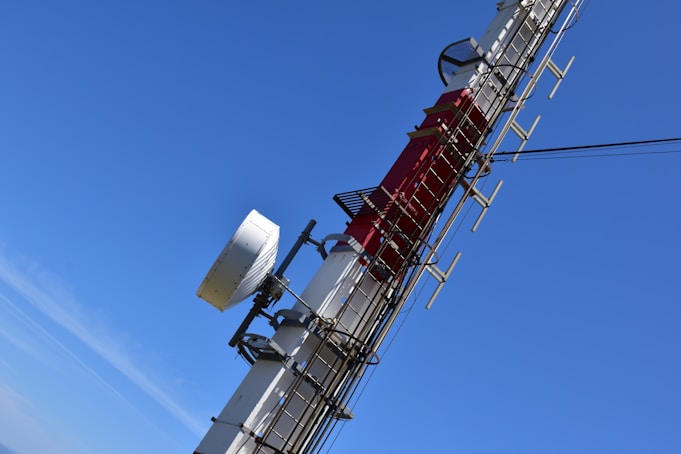 a cell phone tower with a lot of antennas on top of it