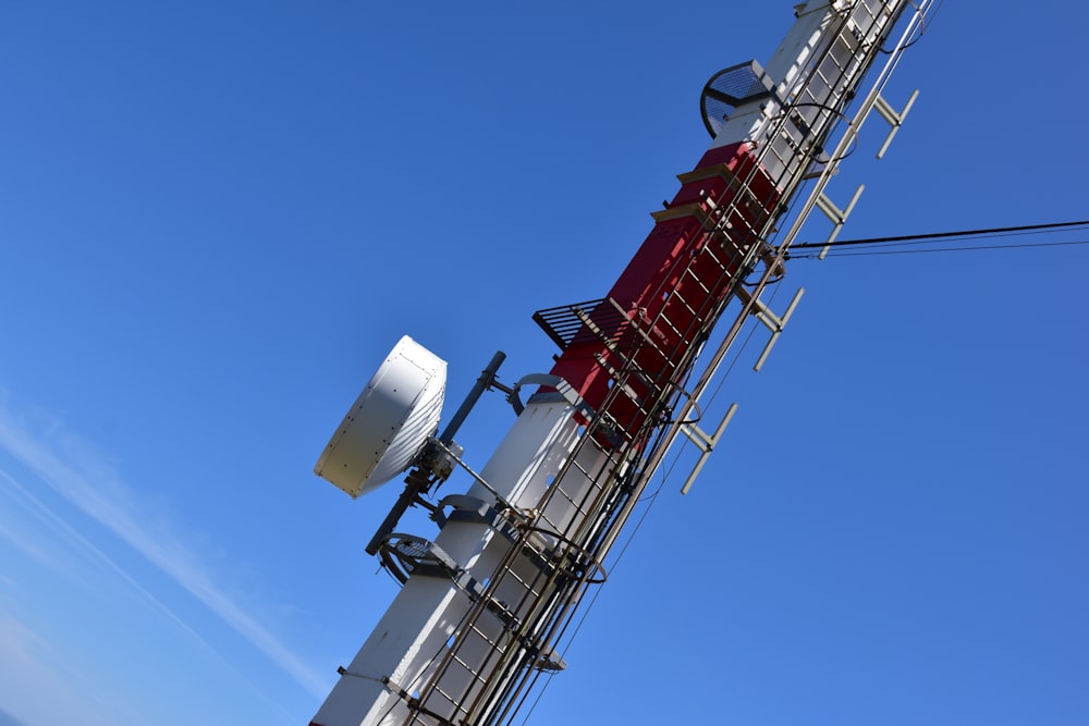 a cell phone tower with a lot of antennas on top of it