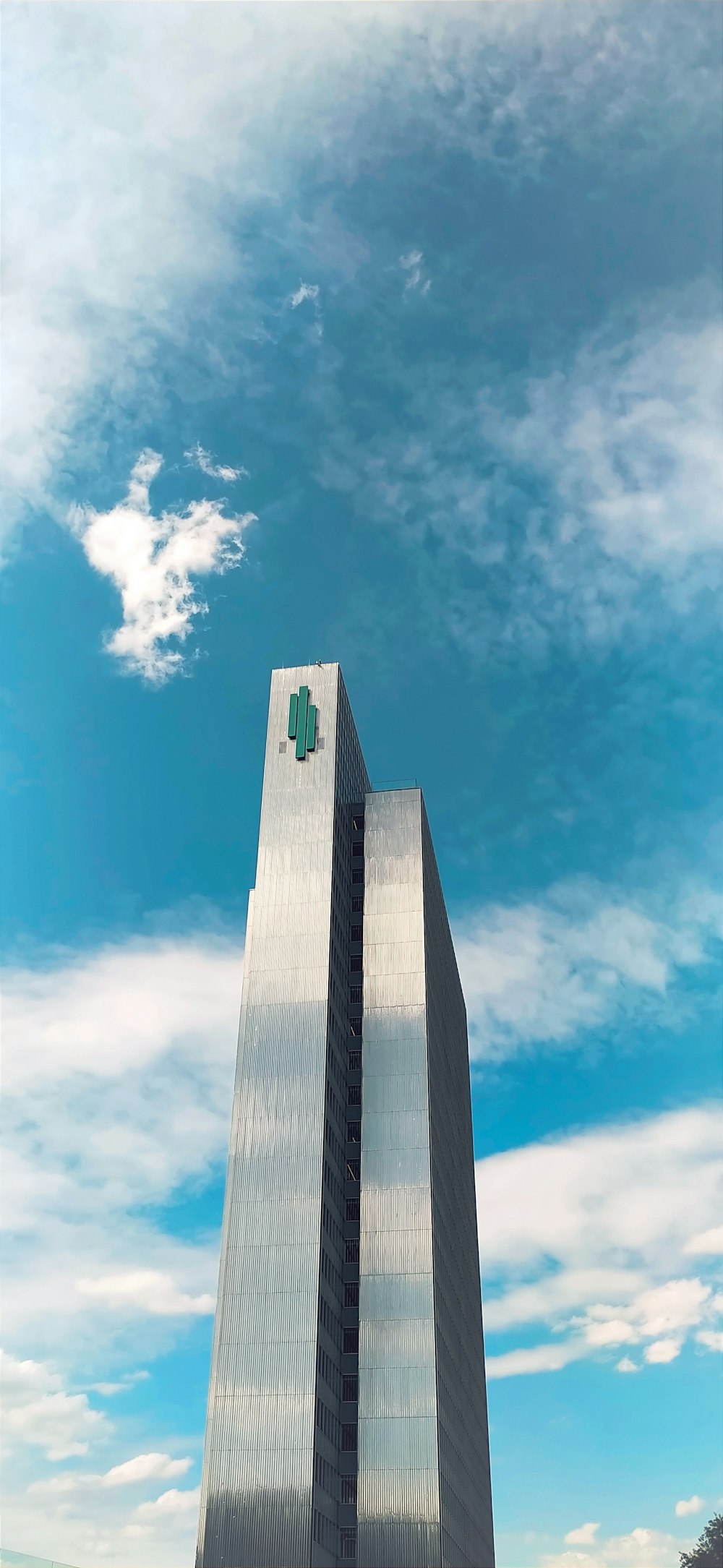 a tall tower with a green cross on it