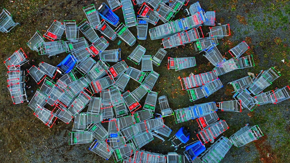 a pile of empty chairs sitting on top of a field