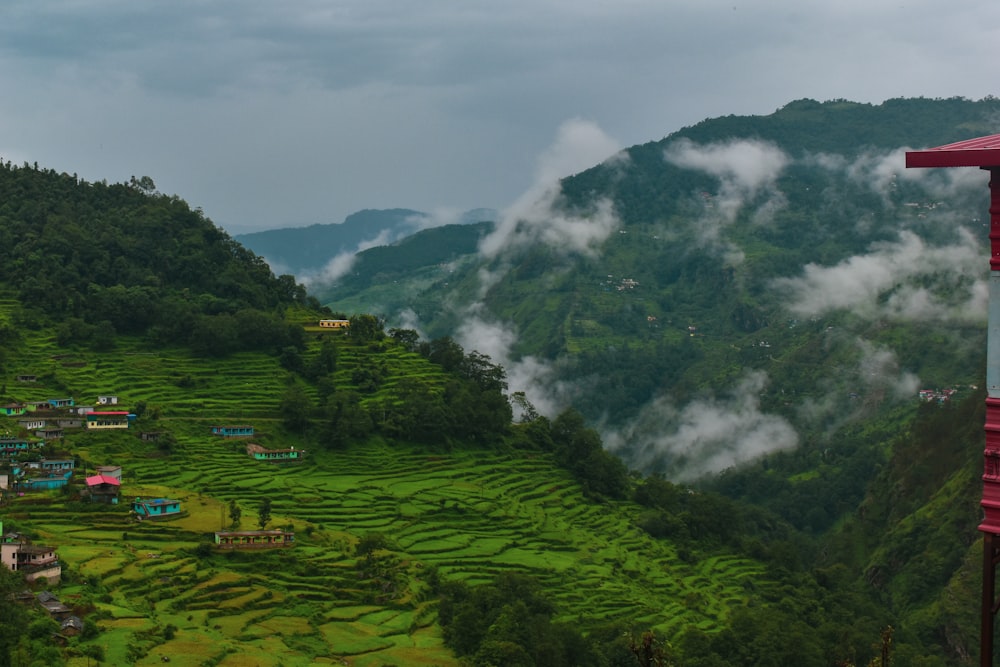 a lush green hillside covered in lots of clouds
