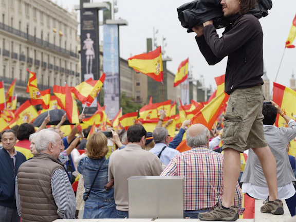 A close-up of a citizen journalist holding a microphone in a bustling city square.