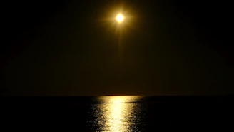 the sun is shining brightly over the water
