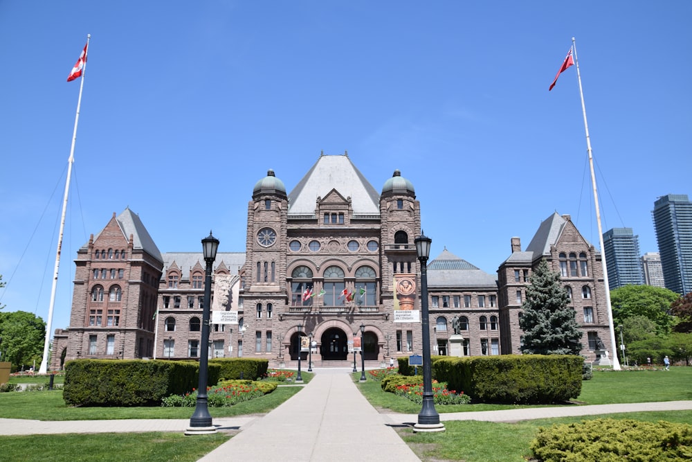 a large building with flags flying in front of it