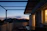 Cozy terrace house balcony with warm evening lights and a view of Melaka’s skyline.