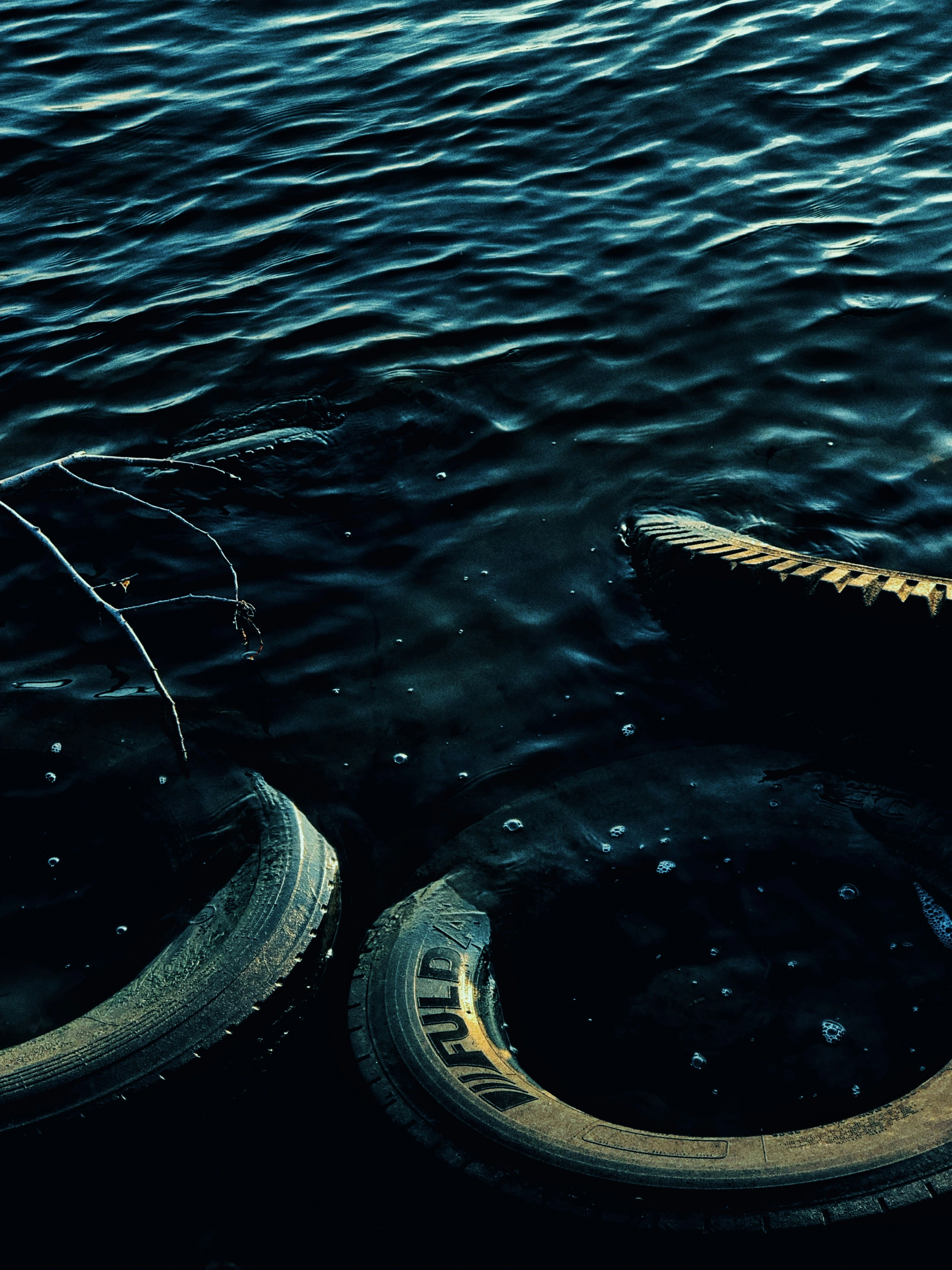 a pair of shoes sitting on top of a body of water