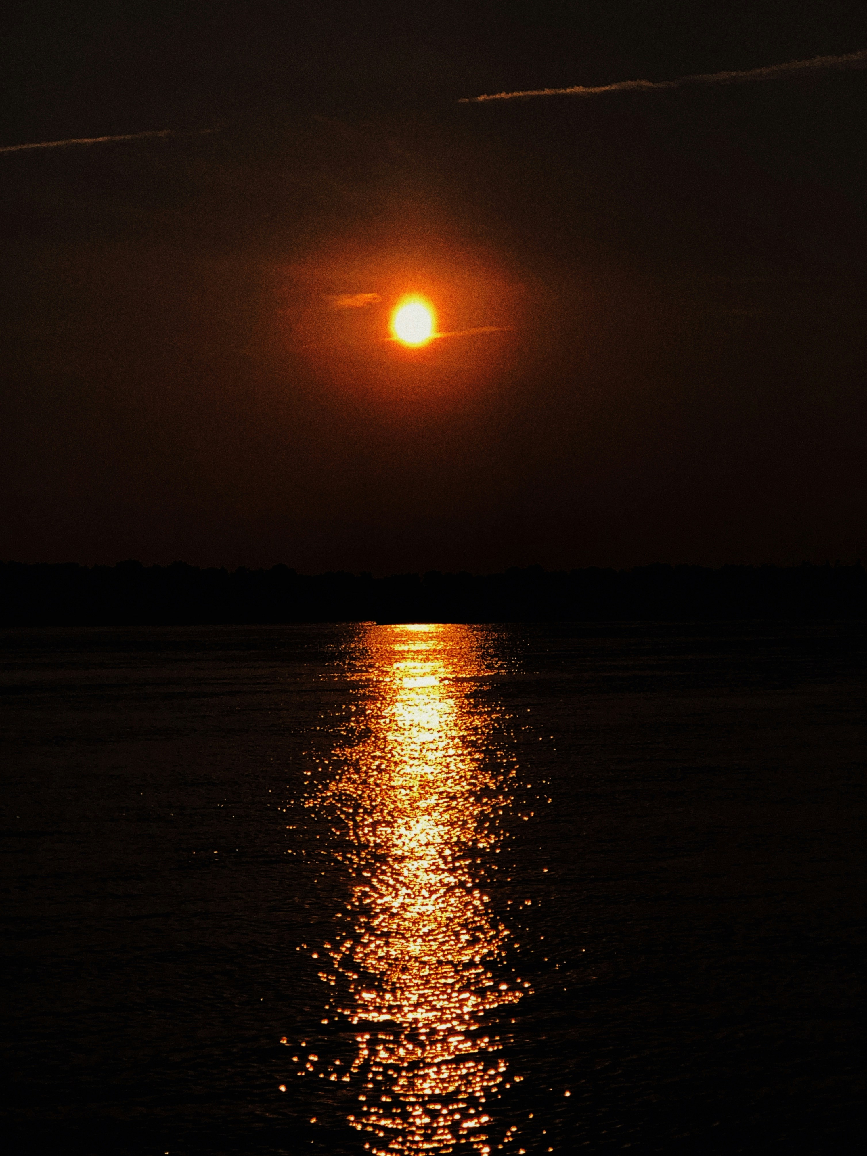 the sun is shining brightly over the water