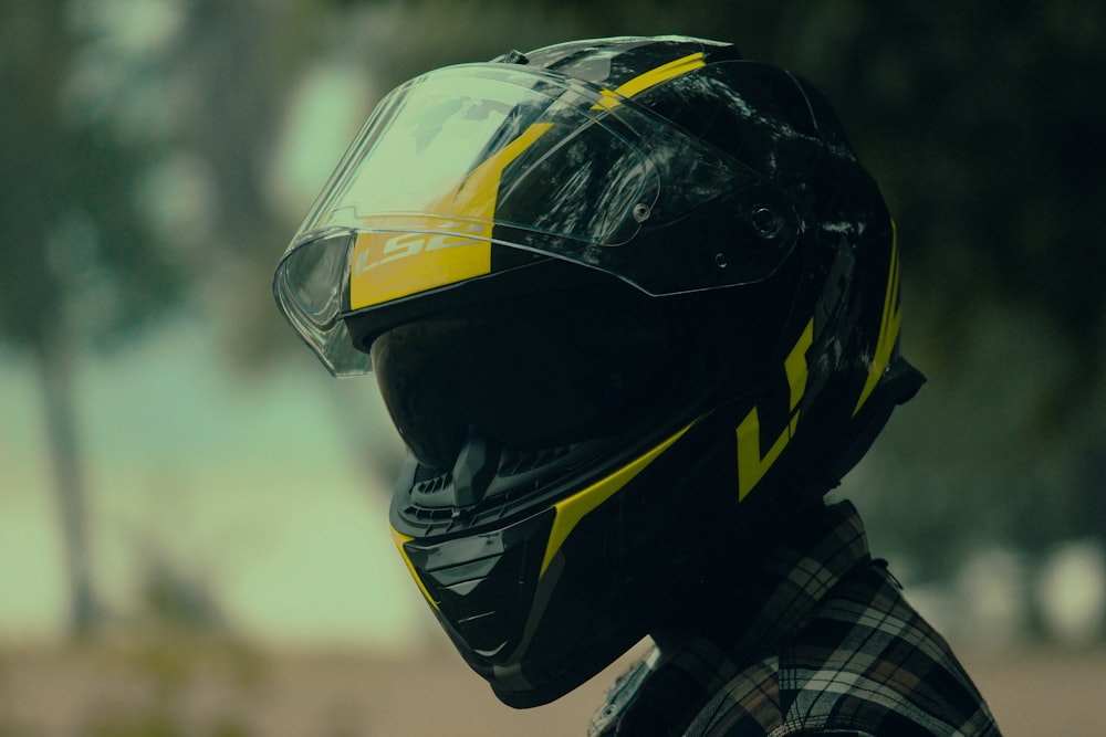 a person wearing a motorcycle helmet and checkered shirt