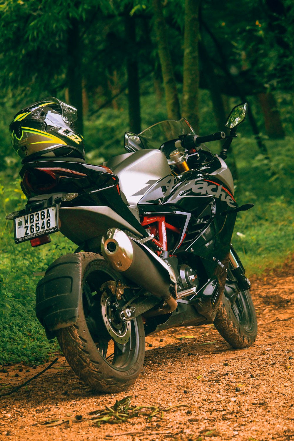 a motorcycle parked on the side of a dirt road