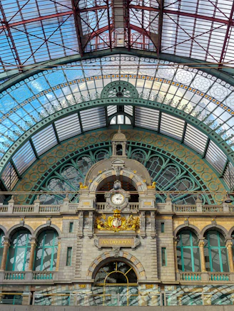 a train station with a clock on the front of it