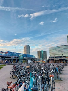 a bunch of bikes parked in a parking lot