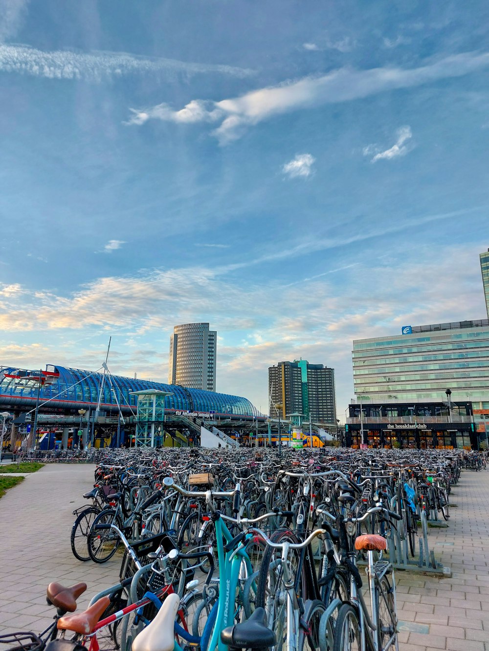 a bunch of bikes parked in a parking lot