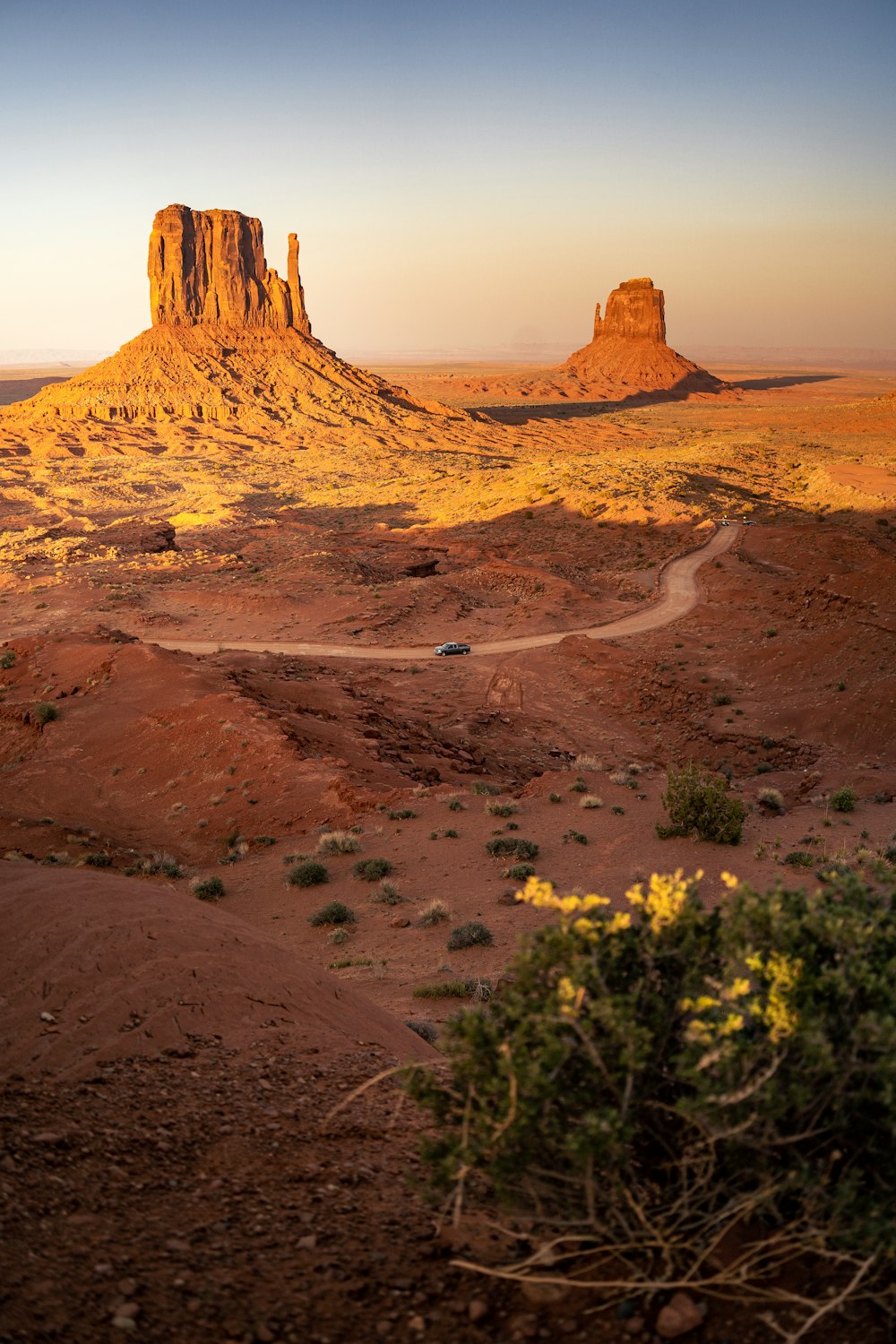 a dirt road in the middle of a desert