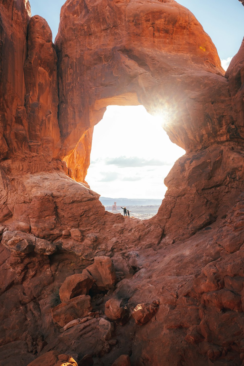 a couple of people standing in the middle of a cave