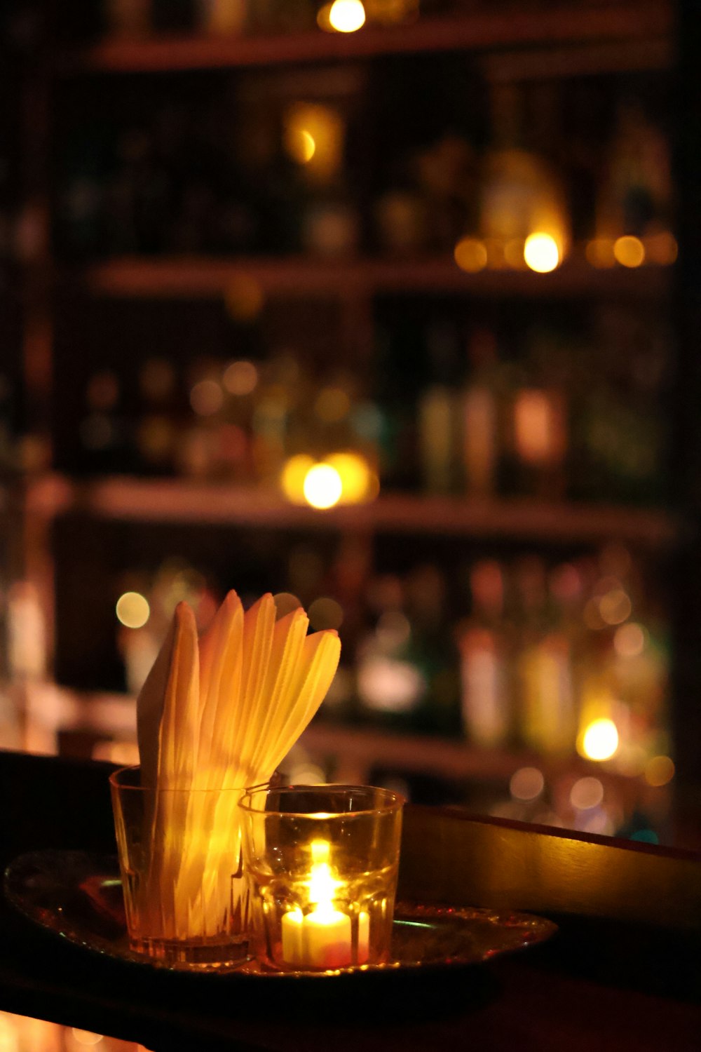 a candle and a glass on a table