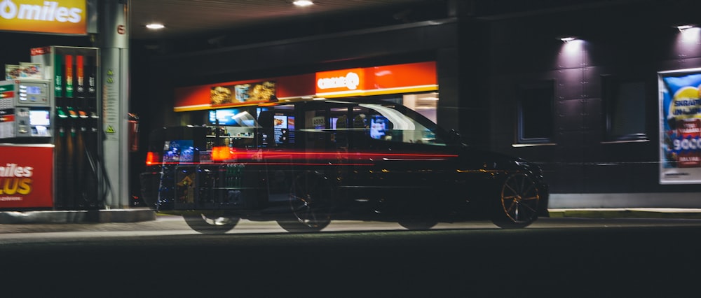 a car parked on the side of the road at night