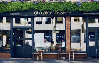 A cozy storefront showcasing various bicycles outdoors on a sunny day
