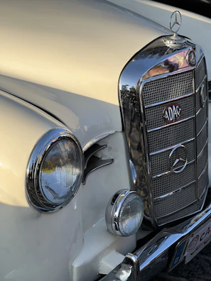 Side view of a vintage Mercedes Benz with freshly restored chrome details