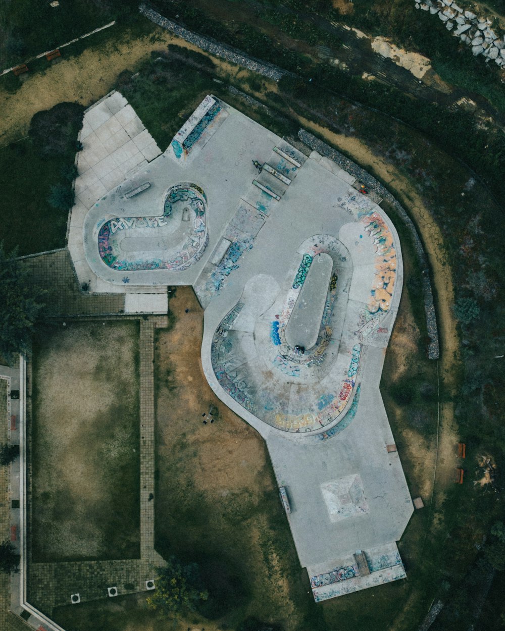 an aerial view of a skate park with ramps