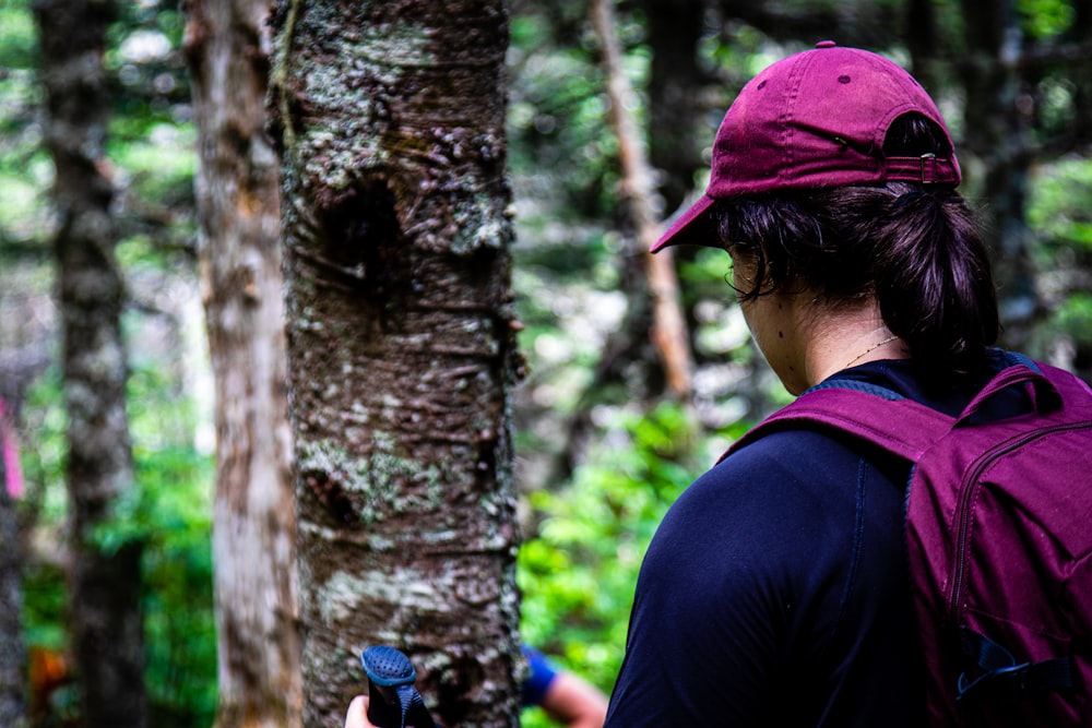 a person with a backpack looking at a tree