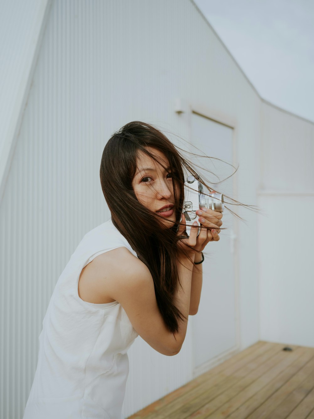 a woman holding a camera up to her face