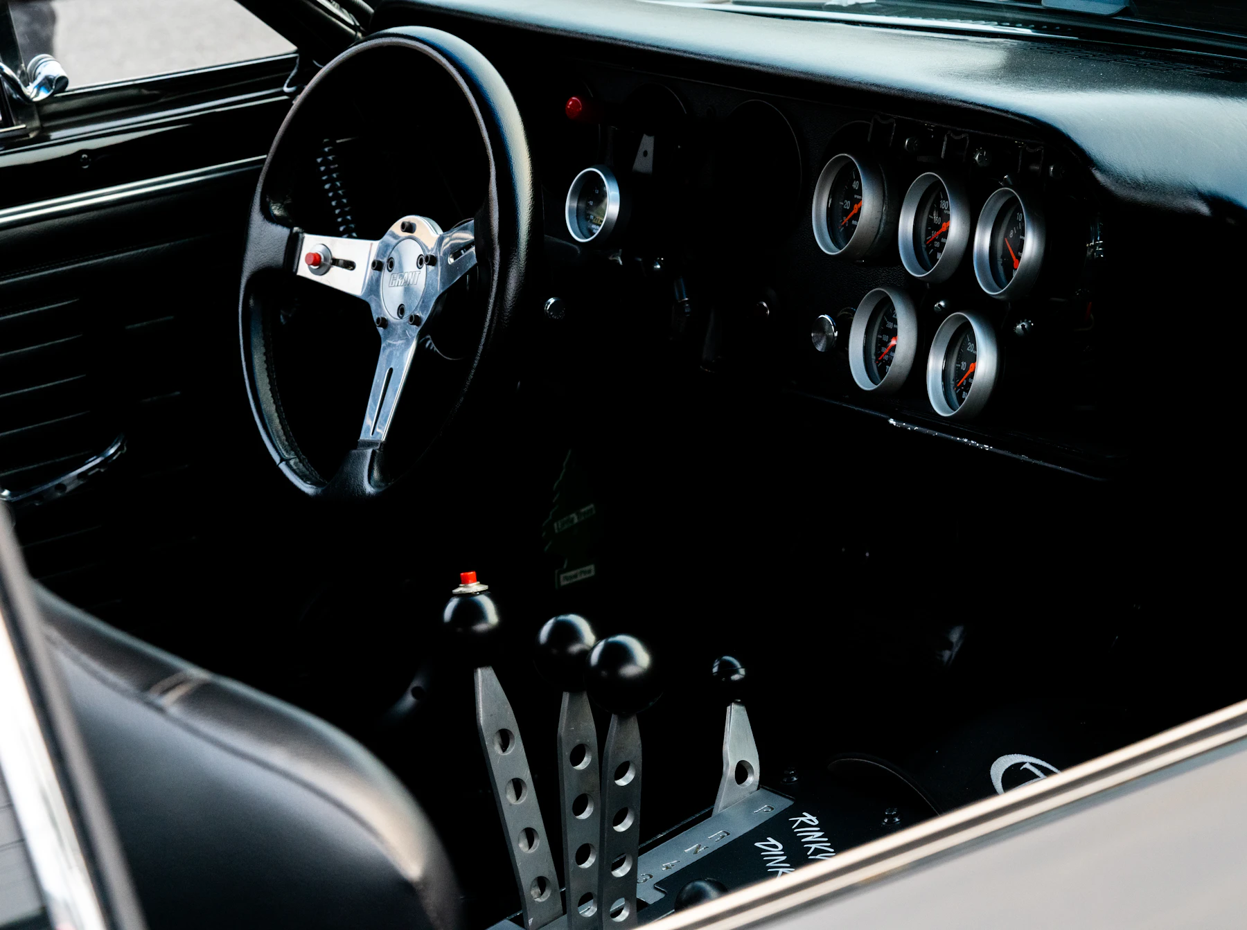 Dark premium car interior with steering wheel and dashboard
