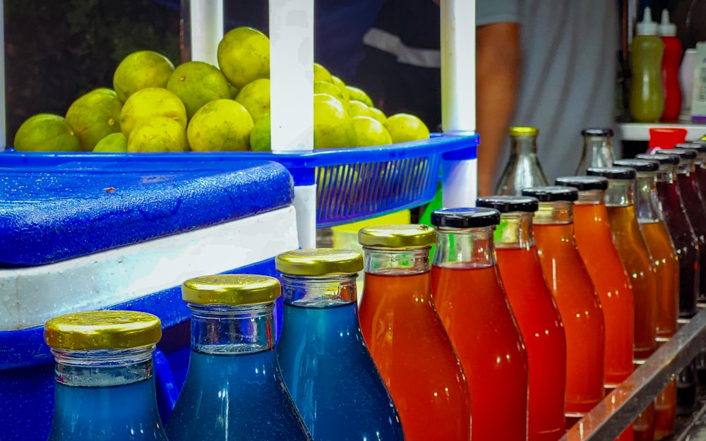 a row of bottles of juice sitting next to each other