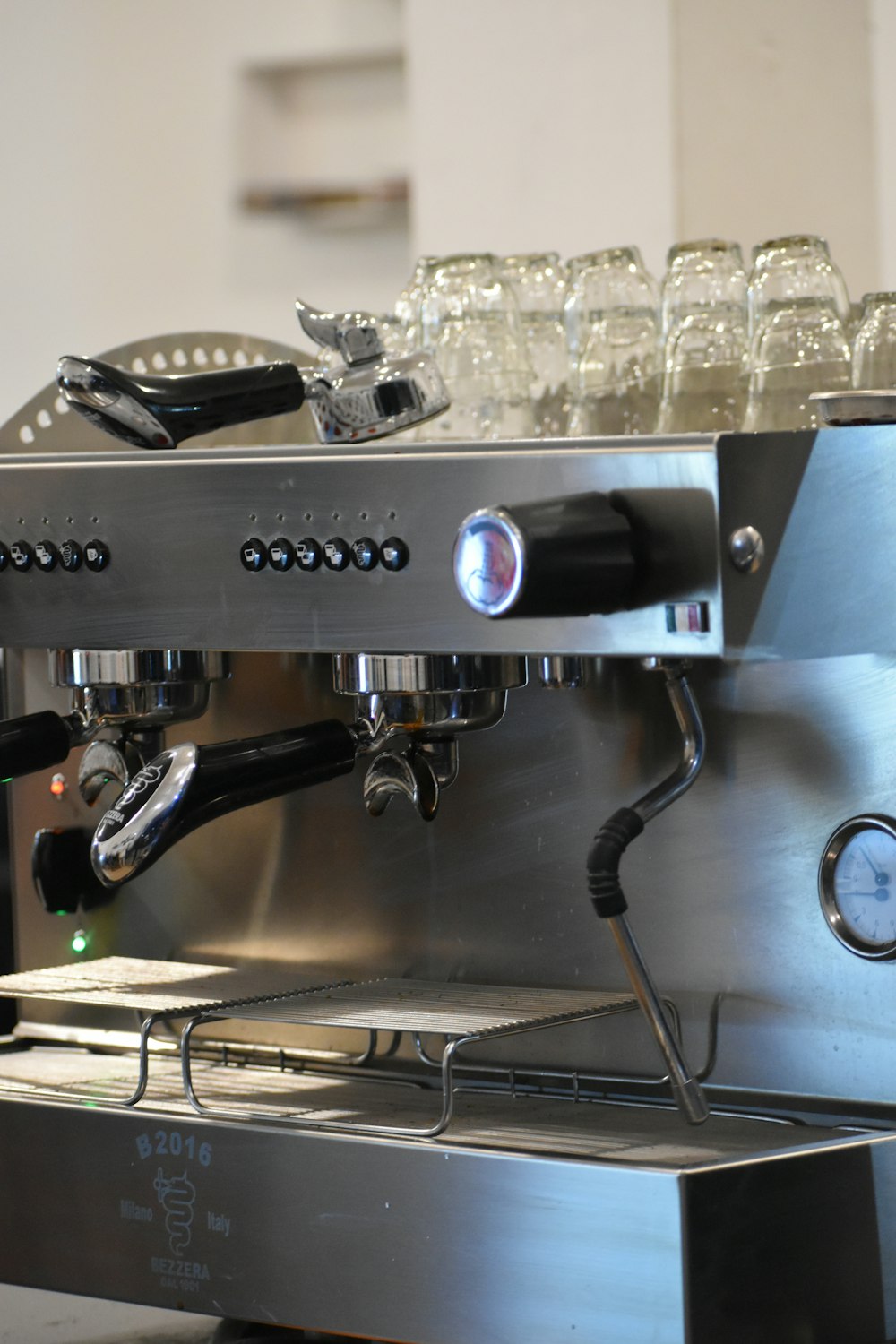 a coffee machine with a clock on the side of it