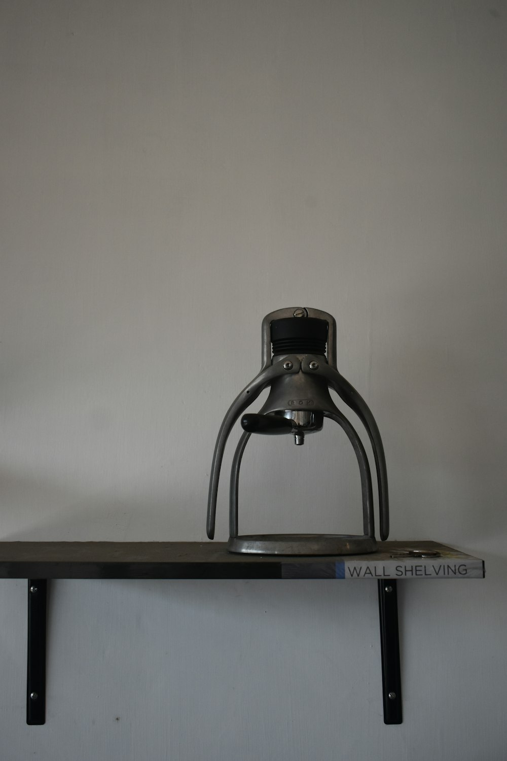 a metal object sitting on top of a shelf