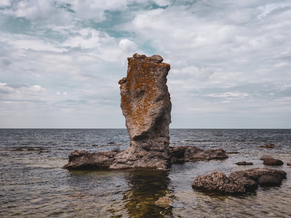 a large rock sticking out of the water