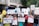A diverse group of people are gathered for a protest or awareness event, holding various colorful signs advocating for disability rights and inclusion. Some signs have text promoting the inclusion of individuals with disabilities in sports and society, with messages like 'I want to turn my disability into ability' and 'Support Disability Rights.' The participants appear engaged and passionate about the cause.
