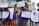 A group of children and adults are holding up various signs advocating for disability rights and inclusion in sports. The signs have messages like 'We want unified sports in the Paralympics to mainstream disability,' 'Support disability rights,' 'Don't look at the less, look at the records,' and 'Yes I can.' The participants are wearing blue shirts with orange and red lettering and are standing on an outdoor street with trees and buildings in the background.