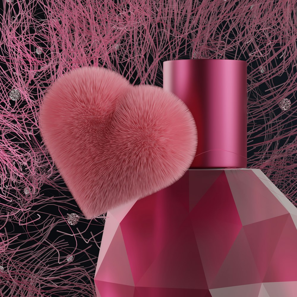 a pink perfume bottle with a pink heart on top of it