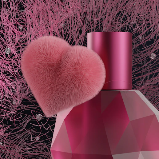 a pink perfume bottle with a pink heart on top of it