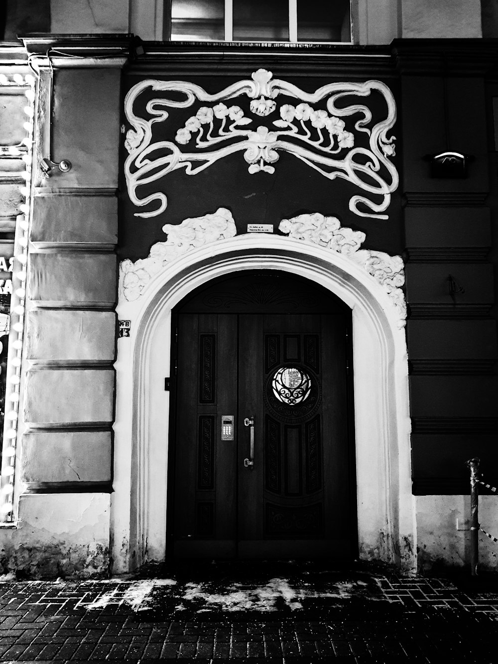 a black and white photo of a building with a door
