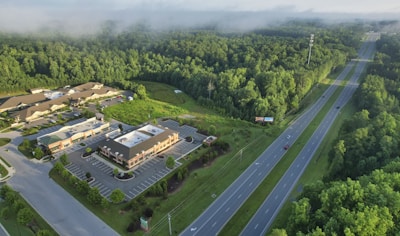 Aerial view of a commercial complex surrounded by greenery