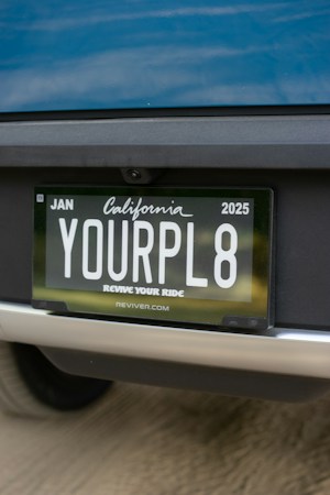 A white car parked along the side of a residential street, the kind of vehicle neighbors report through the Nevada Registration Spotter