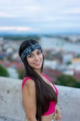 a woman in a pink top is posing for a picture