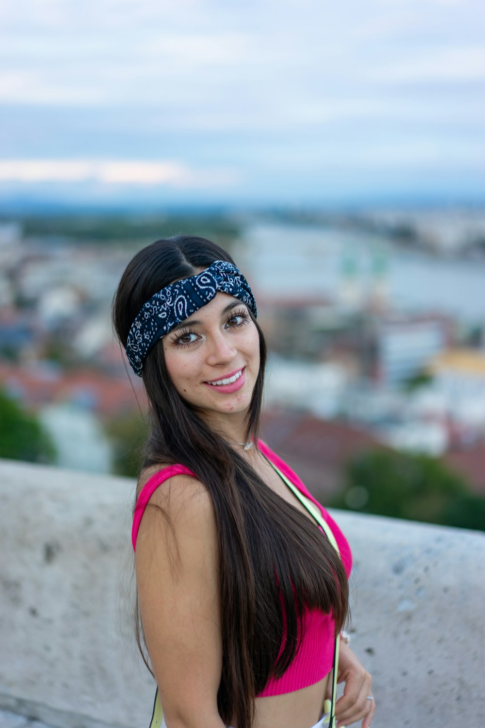 a woman in a pink top is posing for a picture