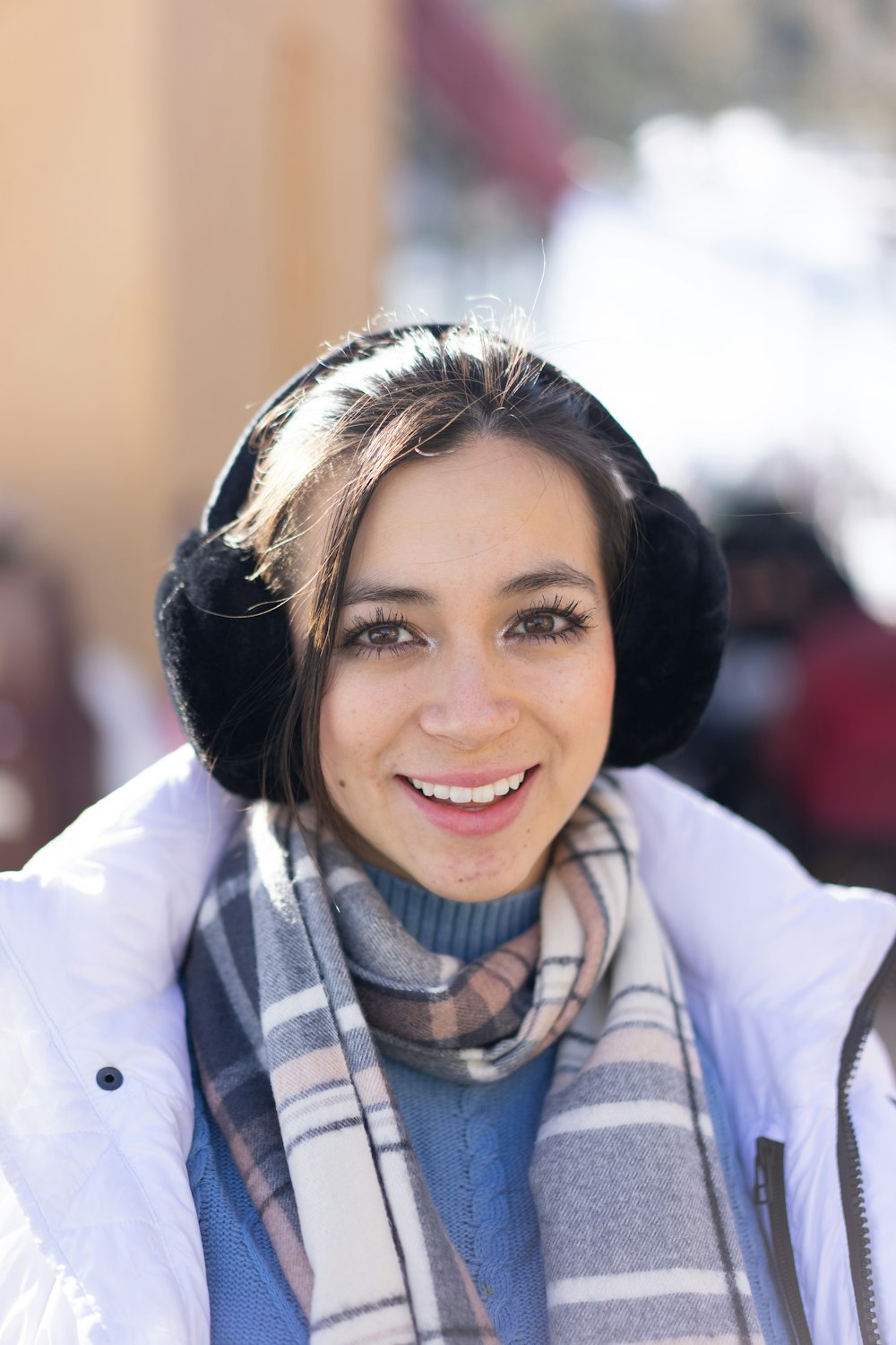 a woman wearing a scarf and a hat